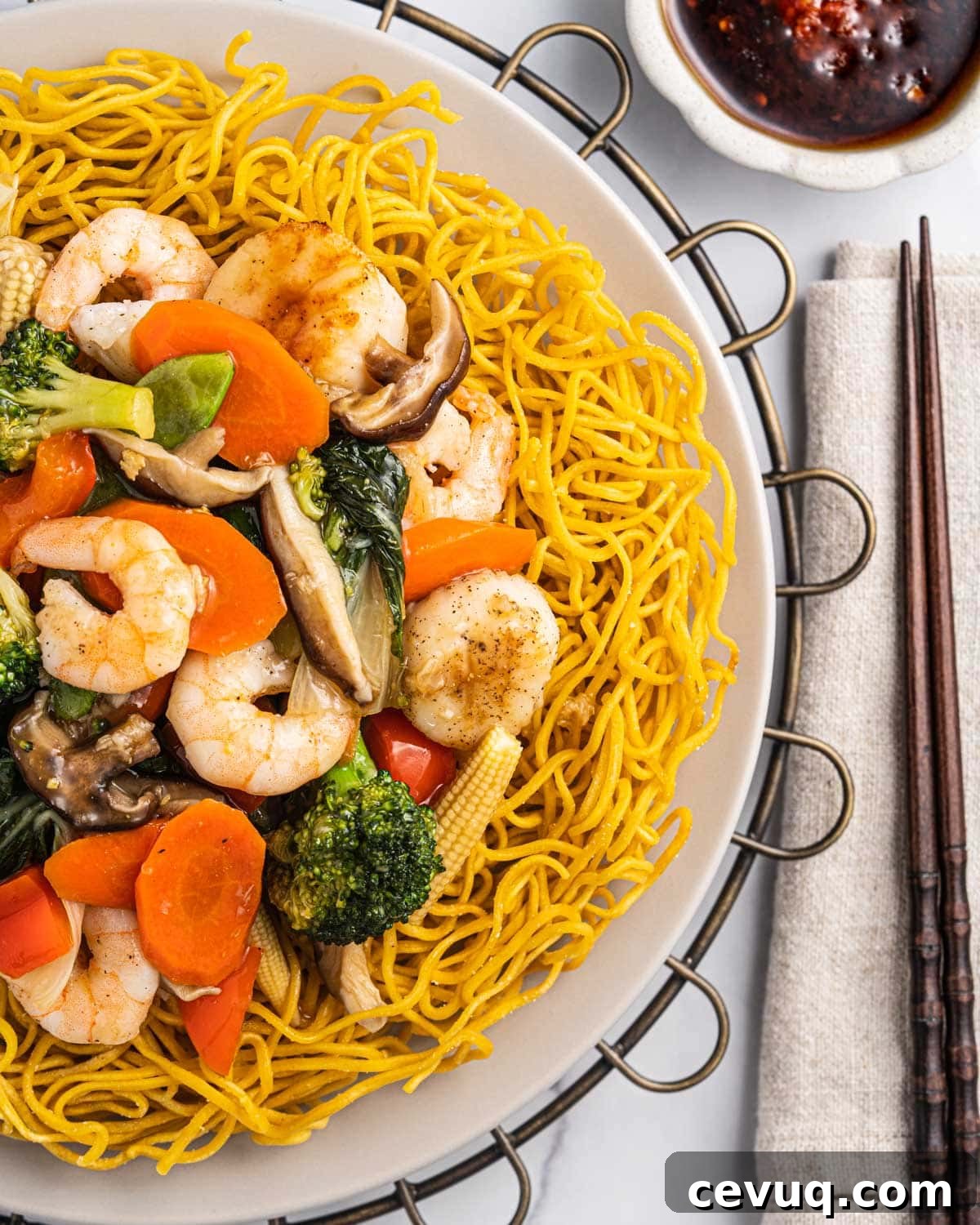 Crispy Pan-Fried Seafood Noodles with Vegetables 3 Mi Xao Don, crispy pan fried noodles, topped with seafood, vegetables, and sauce.