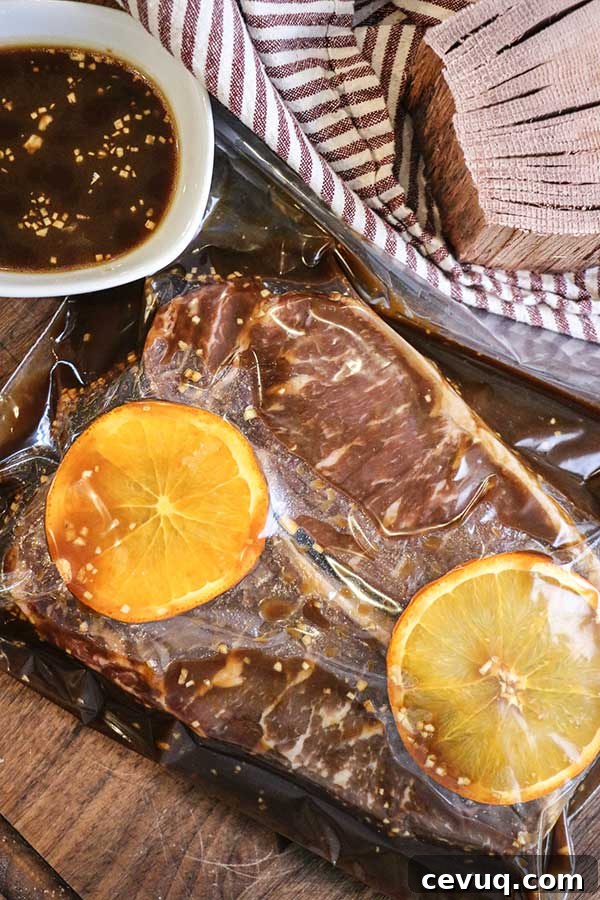 Grilled Bourbon Molasses Marinated Steak Recipe 4 Strip steaks marinating in a bag with orange slices and bourbon marinade