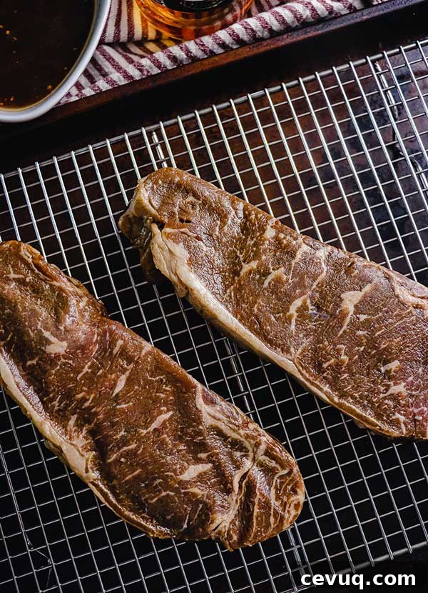 Grilled Bourbon Molasses Marinated Steak Recipe 5 Bourbon marinated strip steak on a rack, patted dry