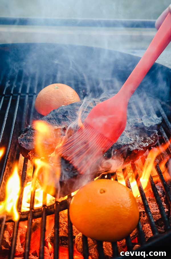 Grilled Bourbon Molasses Marinated Steak Recipe 7 Basting a strip steak with a long handled hi-temp basting brush