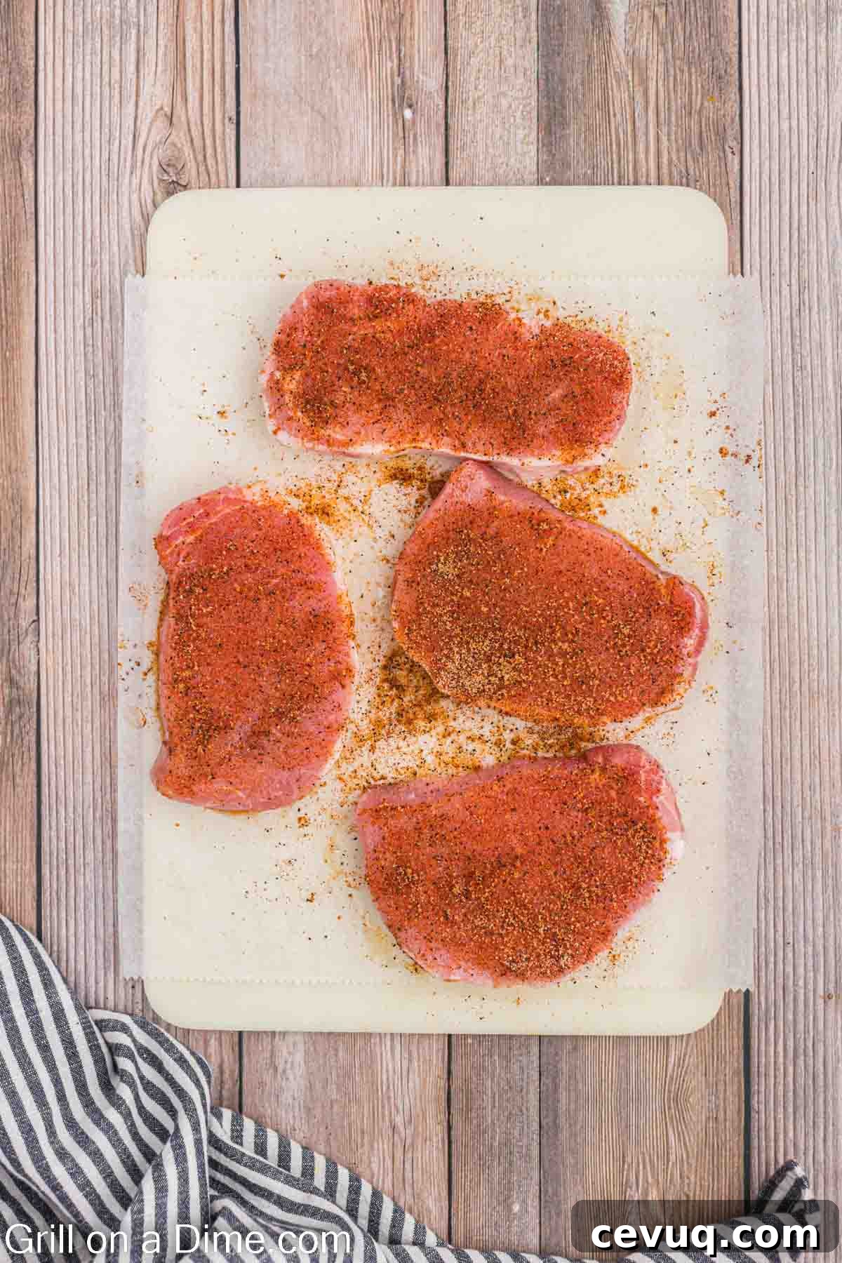 Seasoned pork chops on a cutting board