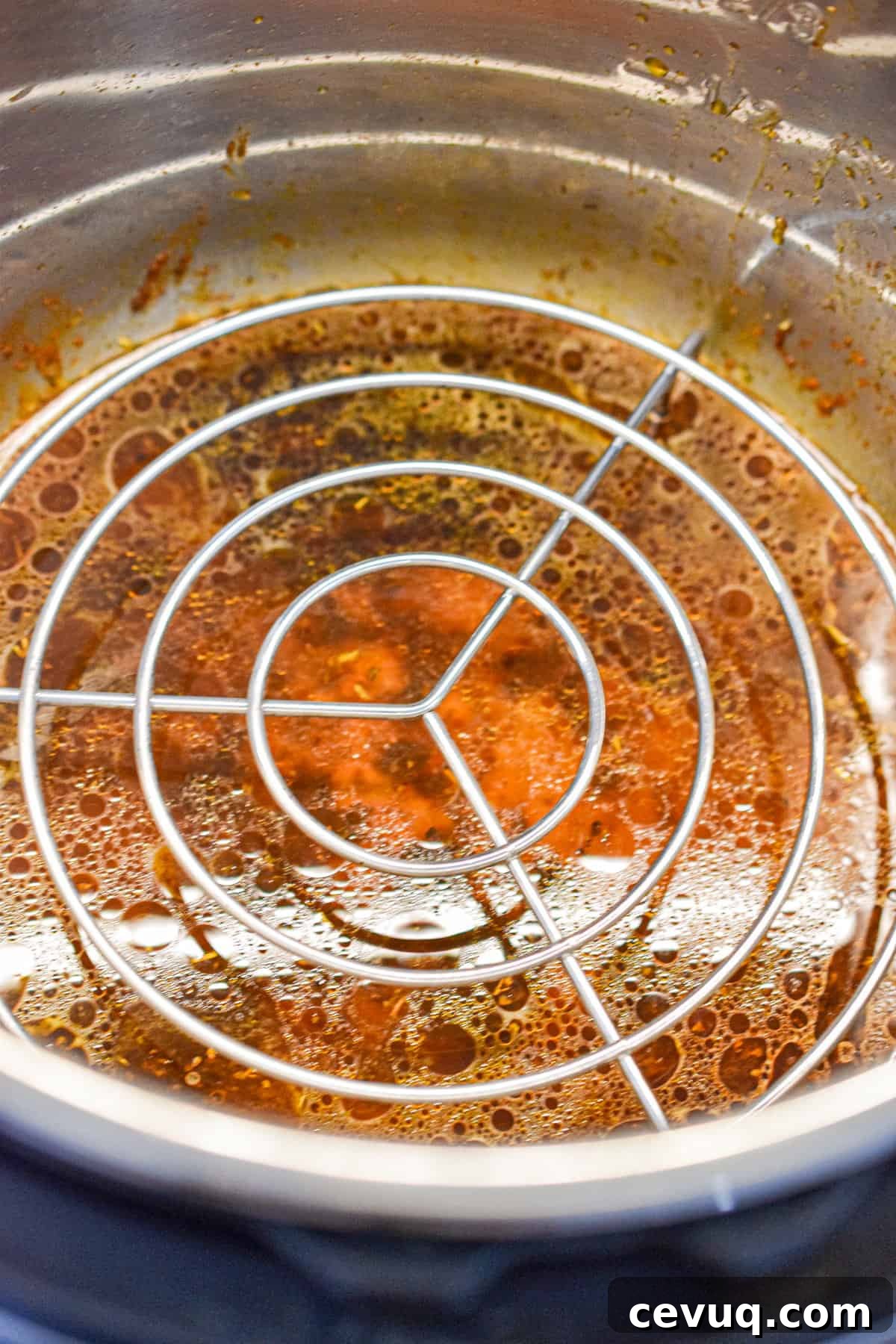 Tender, Juicy Instant Pot Chicken Drumsticks Recipe 8 The Instant Pot is empty with a trivet in the Instant Pot.