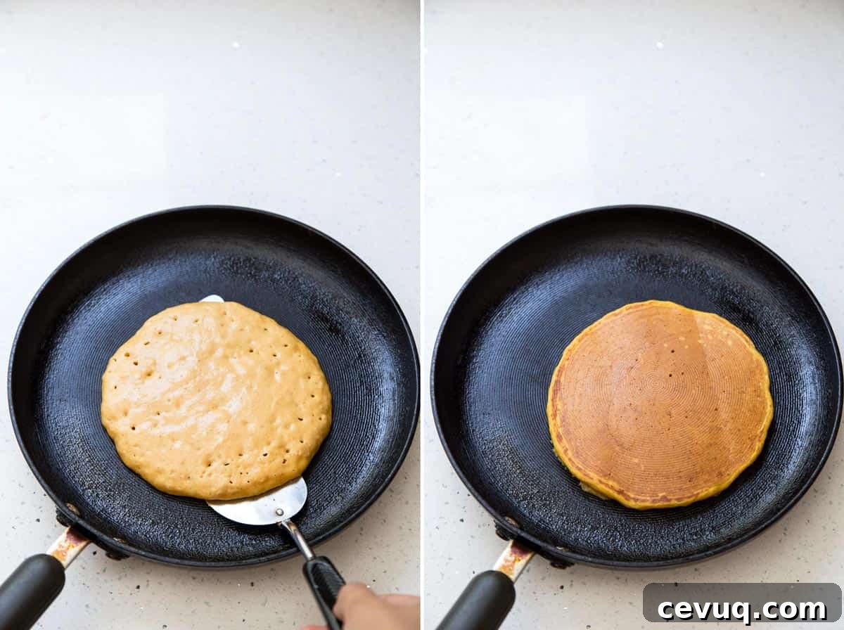Fluffy Buttermilk Pumpkin Spice Pancakes 8 Flipping over a pumpkin pancake to cook the other side.