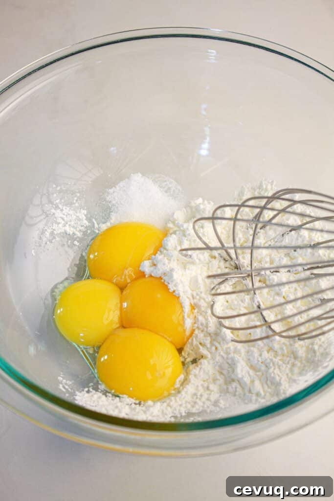 Eggs and cornstarch being whisked together.