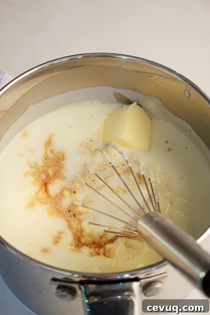 Butter and vanilla being mixed in a saucepan.