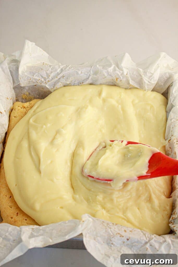 Custard being spread on top of dessert.