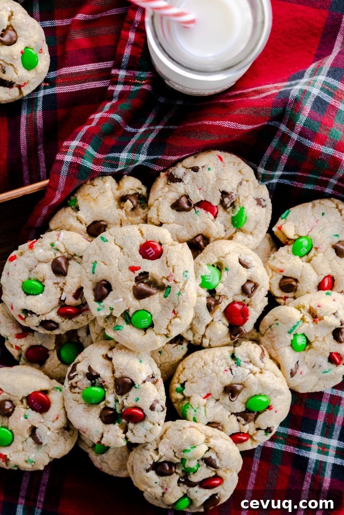 Chocolate chip cookies with M&M's on a Christmas plaid napkin.