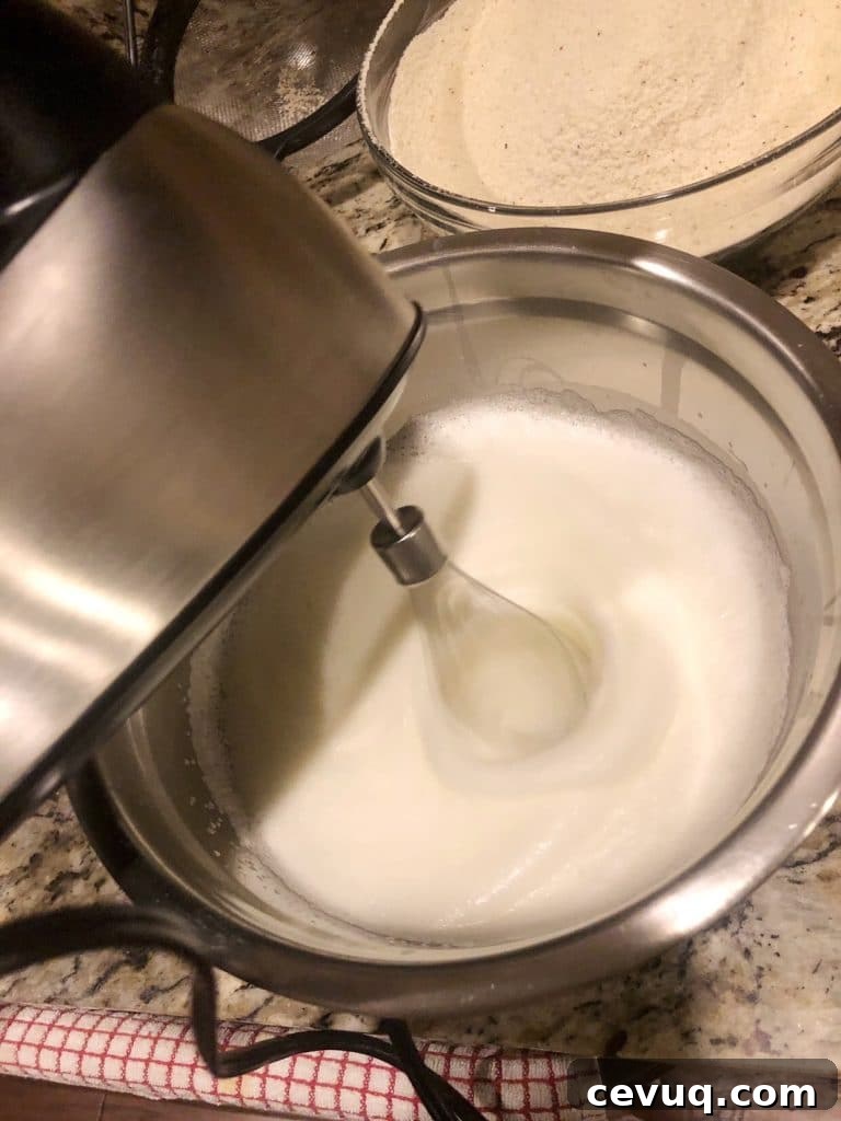 whipping the egg whites with silver mixer