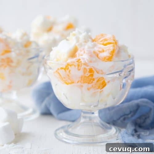 5 cup salad in a glass parfait dish with a blue tea towel nearby.