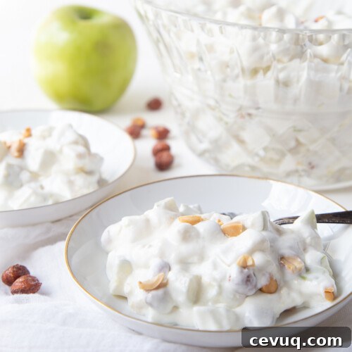 Taffy apple salad in a small white dish with a large glass serving dish in the background