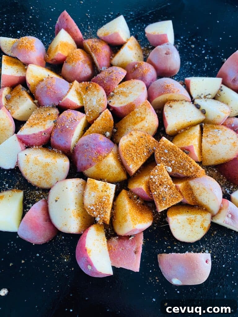 seasoned potatoes on the griddle before cooking