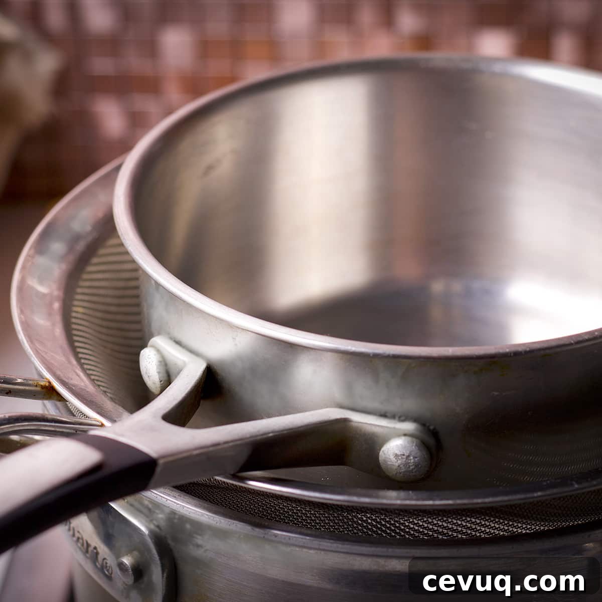 Two saucepans, one medium and one small, and a fine mesh strainer to create a double boiler.