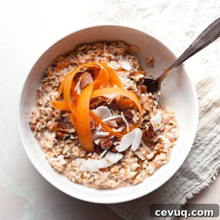 gluten free carrot cake overnight oats in a bowl topped with shredded carrots