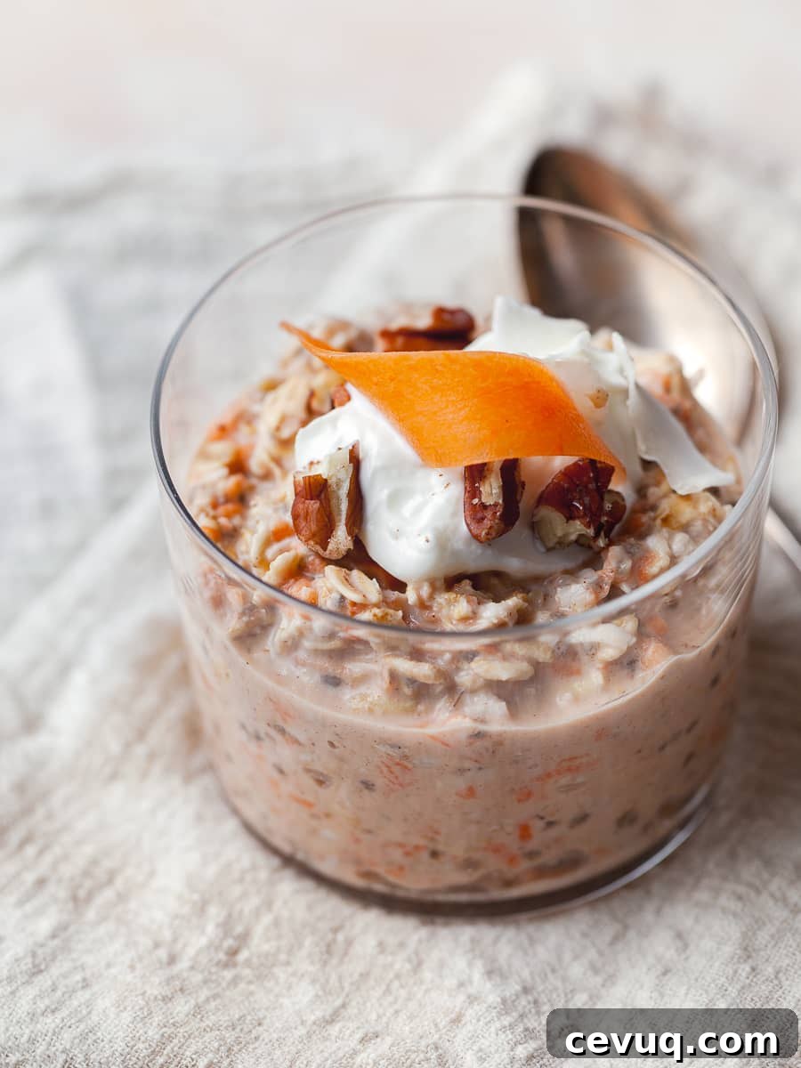 carrot cake overnight oats in a cute glass topped with greek yogurt, carrots and pecans 