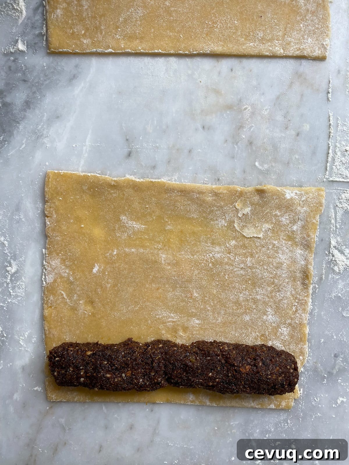 Fig filling added to the rolled out dough on one end.