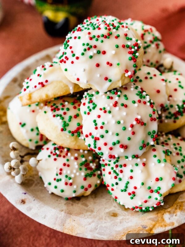 Italian Christmas cookies on a beautiful platter with Christmas decoration around it.