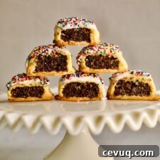 Italian fig cookies stacked on a raised platter.