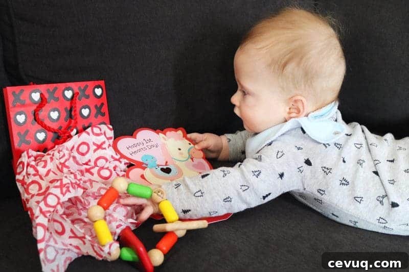 Baby opening a Valentine's present