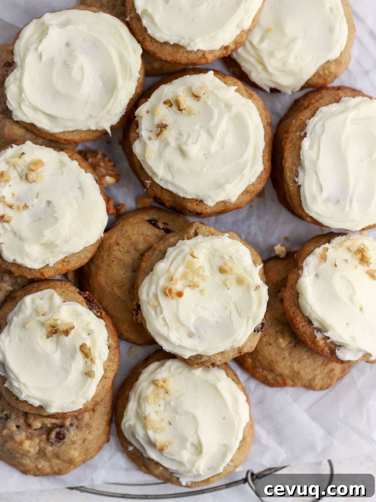 A stack of frosted carrot cookies