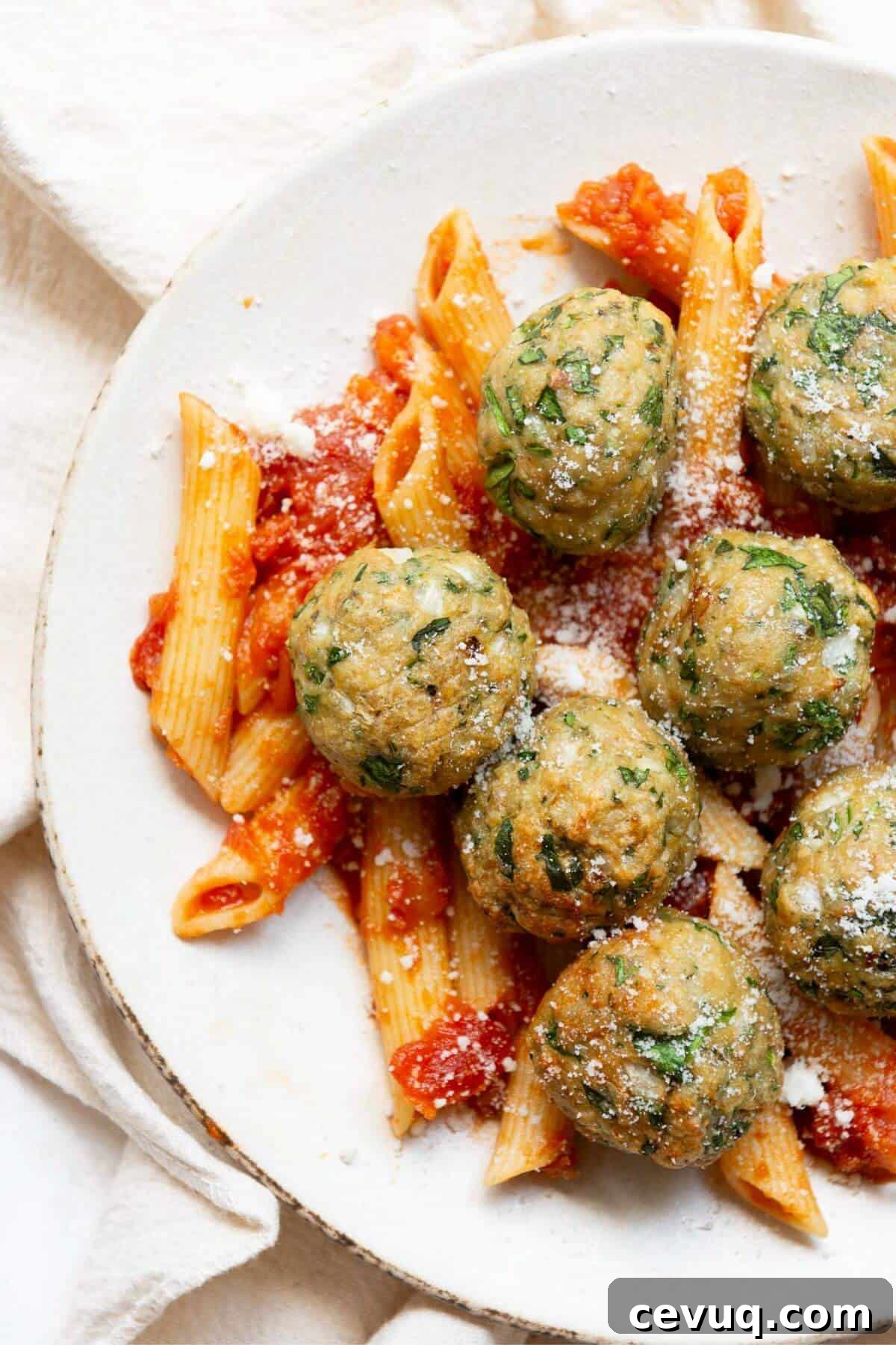 Juicy and crispy air fryer chicken meatballs with pasta, parmesan, and marinara sauce.