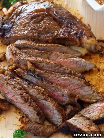 Slices of medium rare juicy ribeye steaks on a cutting board