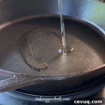 Adding oil to a cast iron skillet.