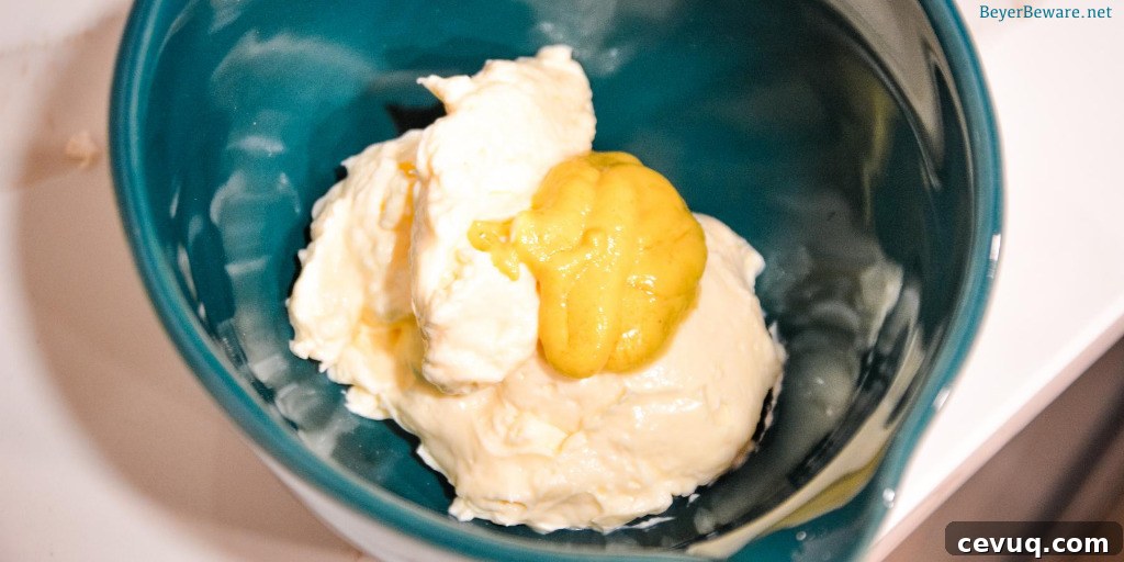 Mixing mayonnaise and dijon mustard