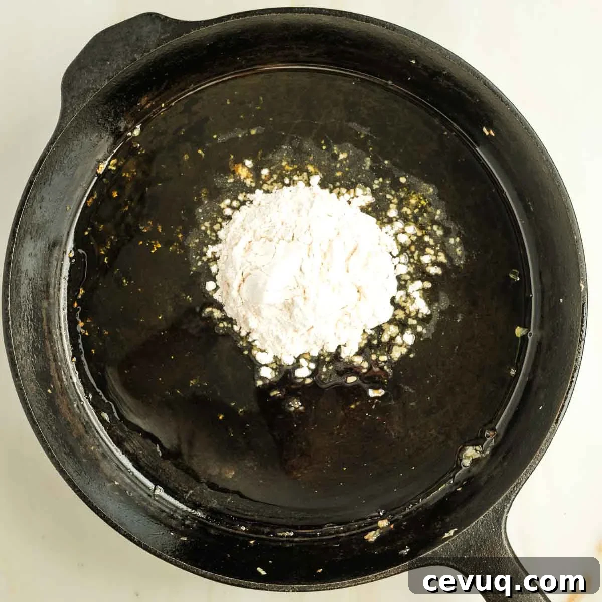Cast iron skillet with oil and flour.