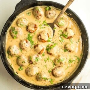 Cast iron pan filled with vegan Swedish meatballs in a creamy sauce.