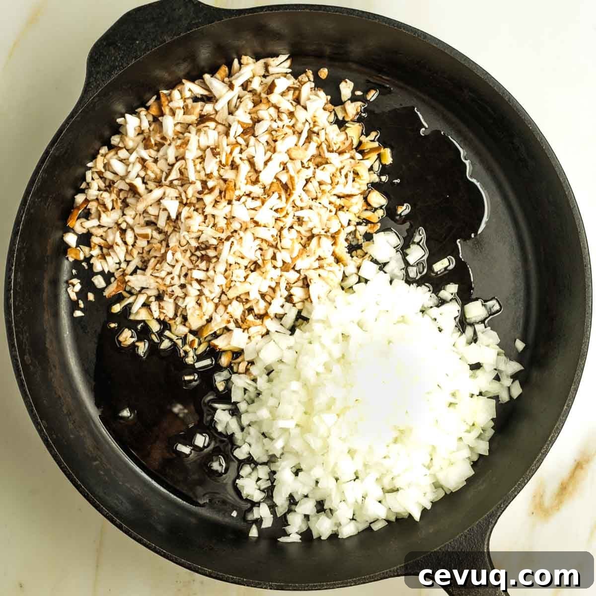 Cast iron skillet with oil, small diced mushrooms and onions.