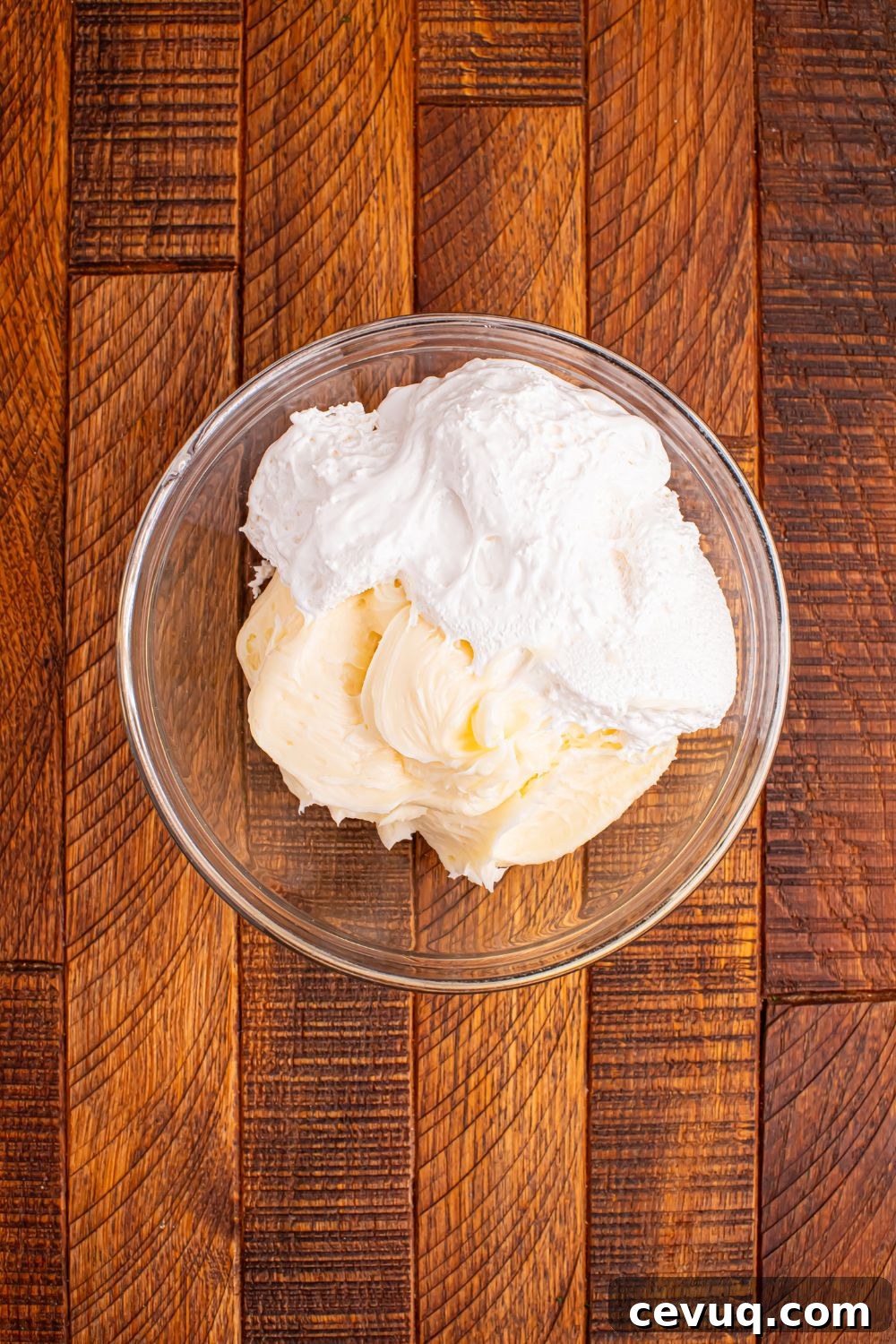 cream cheese frosting and marshmallow fluff in a bowl on wooden table for Christmas Tree Crack