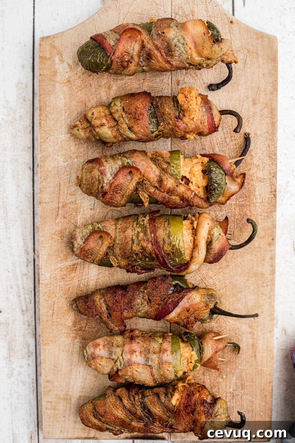 smoked jalapeno poppers on a wooden board.