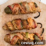 close up of 3 smoked jalapeno poppers.